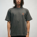 Person wearing a dark gray t-shirt with a small Korean tiger and 광복 on the front on a plain background