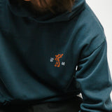 Person wearing a navy hoodie with a small tiger graphic and 광복 text on the chest.