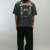 Person wearing a dark gray t-shirt with floral designs and text on the back for Korean Liberation Day, standing against a plain background.