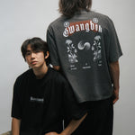 Two people wearing black and gray t-shirts with KORELIMITED and GWANGBOK graphic designs on a plain background