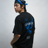 Person wearing a black t-shirt with blue dove bird graphics and white text, standing against a plain background