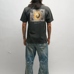 Person wearing a black t-shirt with a Korean Flag graphic design on the back, standing against a plain background.