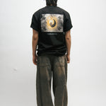 Person wearing a black t-shirt with a Korean Flag graphic design on the back, standing against a white background